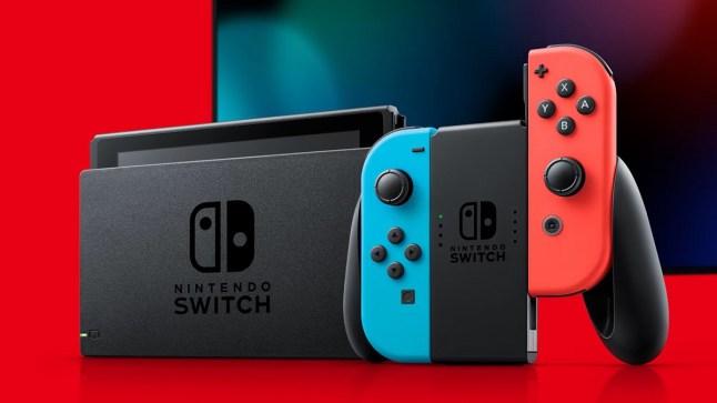 Nintendo Switch console with controller in front of TV and red background