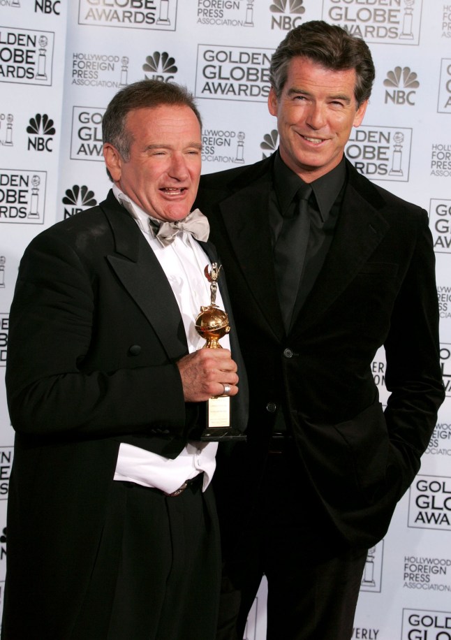 BEVERLY HILLS, CA - JANUARY 16: Actor Robin Williams poses with his award as recipient of the Cecil B. DeMille Award with presenter Pierce Brosnan during the 62nd Annual Golden Globe Awards at the Beverly Hilton Hotel January 16, 2005 in Beverly Hills, California. (Photo by Kevin Winter/Getty Images)